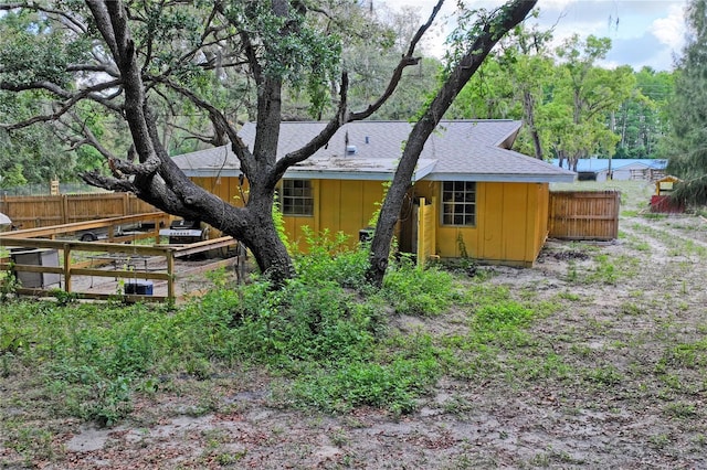 8828 Jasmine Blvd, Port Richey, FL 34668 - back of house with board and batten siding and roof with shingles