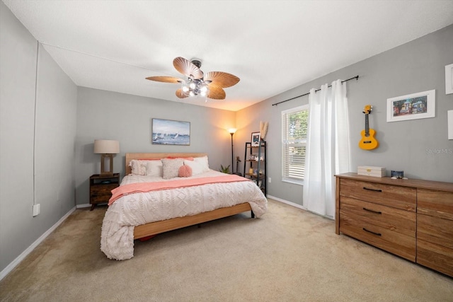 bedroom with light carpet, baseboards, and ceiling fan