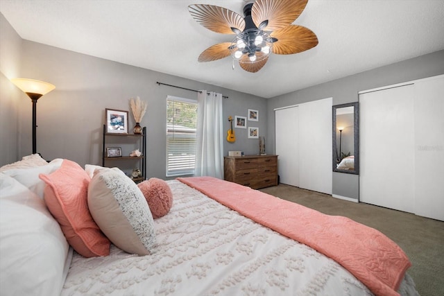 bedroom with multiple closets, carpet flooring, and a ceiling fan