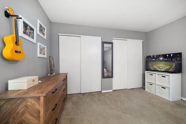 carpeted bedroom with multiple closets