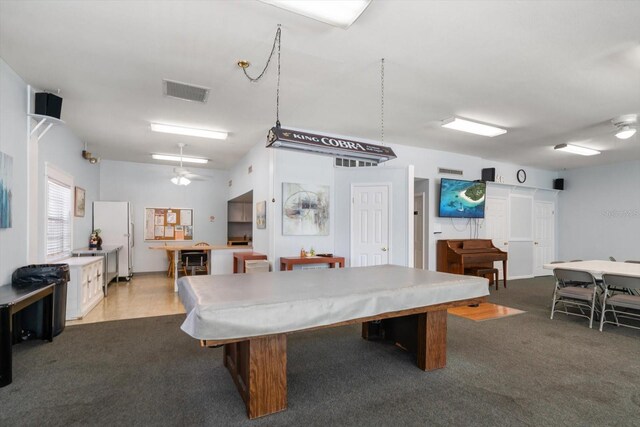 recreation room with dark carpet
