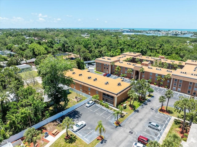 drone / aerial view of a large body of water and apartment complex / building