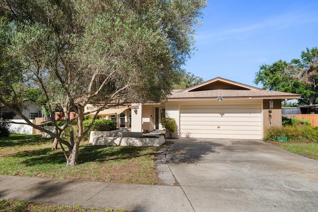 1142 Lancer Ln, Tarpon Springs, FL 34689 - ranch-style house with driveway, a garage, and stucco siding