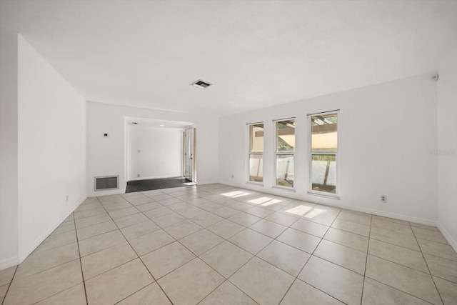 1142 Lancer Ln, Tarpon Springs, FL 34689 - empty room featuring light tile patterned floors and baseboards