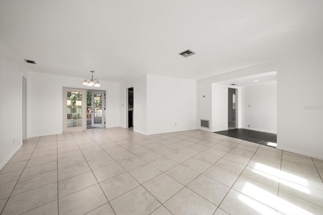 1142 Lancer Ln, Tarpon Springs, FL 34689 - empty room with a chandelier, tile patterned flooring, and baseboards