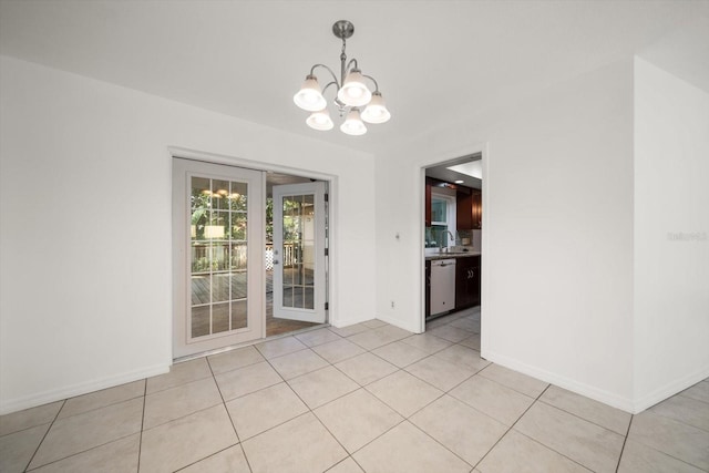 1142 Lancer Ln, Tarpon Springs, FL 34689 - empty room featuring a chandelier, a sink, baseboards, and light tile patterned flooring