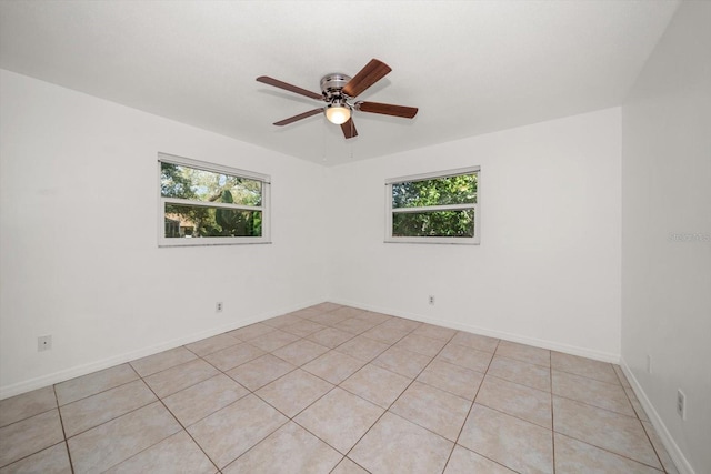 1142 Lancer Ln, Tarpon Springs, FL 34689 - spare room featuring healthy amount of natural light, ceiling fan, and light tile patterned flooring