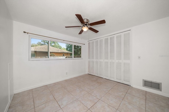 1142 Lancer Ln, Tarpon Springs, FL 34689 - spare room with ceiling fan, light tile patterned floors, and baseboards