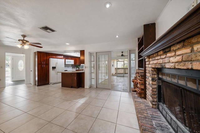 1142 Lancer Ln, Tarpon Springs, FL 34689 - unfurnished living room featuring ceiling fan, a fireplace, light tile patterned flooring, and recessed lighting