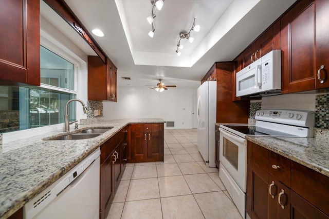 1142 Lancer Ln, Tarpon Springs, FL 34689 - kitchen with white appliances, a sink, a raised ceiling, light tile patterned floors, and light stone countertops