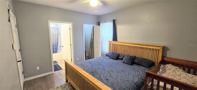 15124 Deer Meadow Dr, Lutz, FL 33559 - bedroom featuring wood finished floors, baseboards, ensuite bathroom, and a ceiling fan