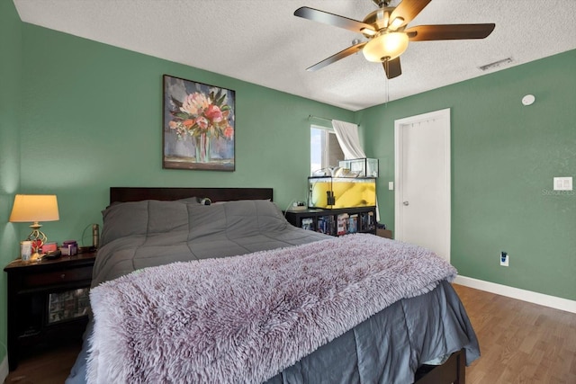 10265 Gandy Blvd N Unit 906, Saint Petersburg, FL 33702 - bedroom with a textured ceiling, wood finished floors, ceiling fan, and baseboards