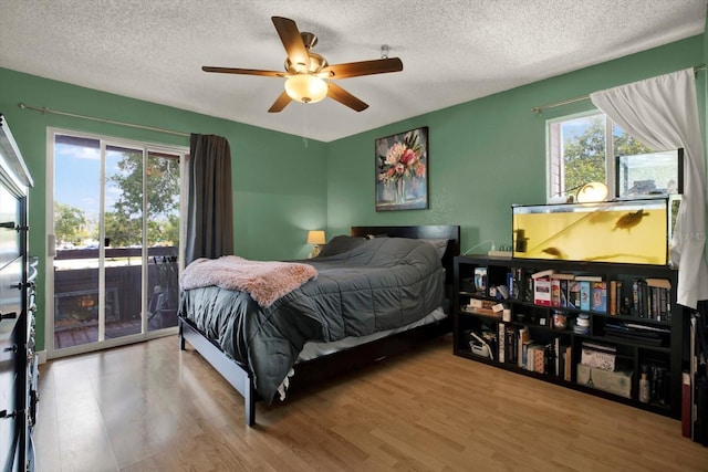 10265 Gandy Blvd N Unit 906, Saint Petersburg, FL 33702 - bedroom featuring access to exterior, wood finished floors, a textured ceiling, and a ceiling fan