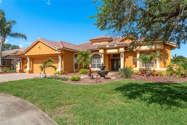 800 Belted Kingfisher Dr S, Palm Harbor, FL 34683 - mediterranean / spanish-style home featuring french doors, stucco siding, a garage, a tiled roof, and a front yard