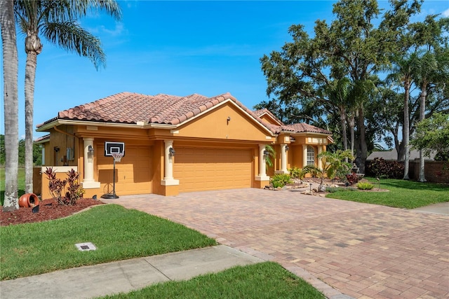 800 Belted Kingfisher Dr S, Palm Harbor, FL 34683 - mediterranean / spanish house with an attached garage, a front lawn, decorative driveway, stucco siding, and a tiled roof