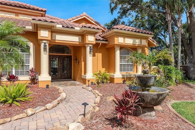 800 Belted Kingfisher Dr S, Palm Harbor, FL 34683 - entrance to property with french doors, stucco siding, and a tile roof