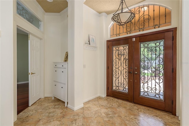 800 Belted Kingfisher Dr S, Palm Harbor, FL 34683 - entrance foyer with french doors, ornamental molding, baseboards, and stone finish flooring