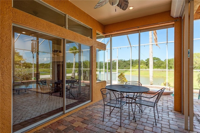 800 Belted Kingfisher Dr S, Palm Harbor, FL 34683 - sunroom / solarium featuring a ceiling fan, a water view, view of scattered trees, and plenty of natural light