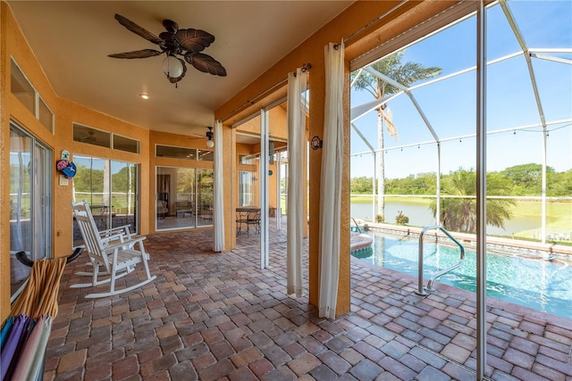 800 Belted Kingfisher Dr S, Palm Harbor, FL 34683 - unfurnished sunroom with ceiling fan, a water view, and a swimming pool