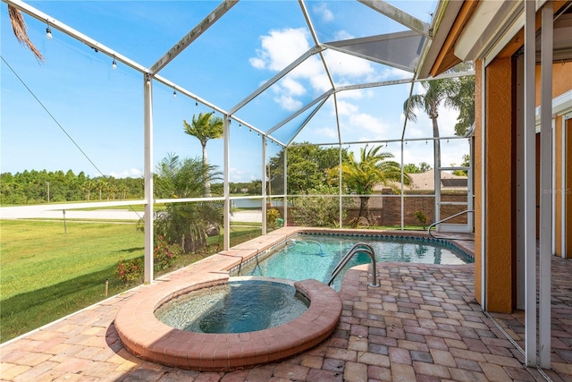 800 Belted Kingfisher Dr S, Palm Harbor, FL 34683 - view of swimming pool featuring a patio, a yard, a pool with connected hot tub, and glass enclosure