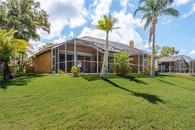 800 Belted Kingfisher Dr S, Palm Harbor, FL 34683 - rear view of property with a chimney, a lawn, and stucco siding