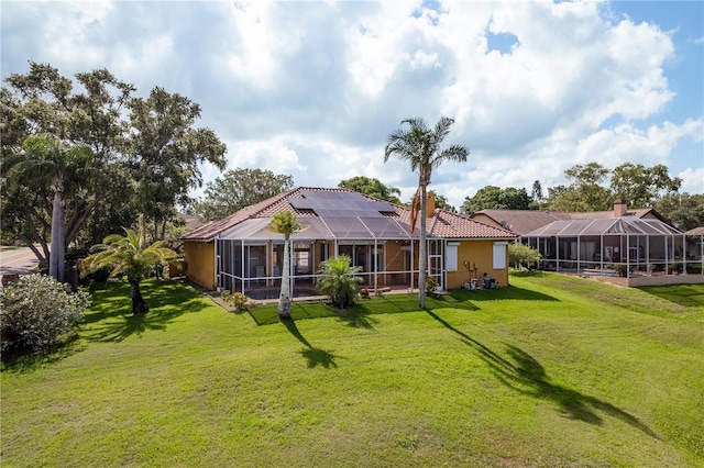 800 Belted Kingfisher Dr S, Palm Harbor, FL 34683 - back of property featuring a lawn, glass enclosure, and a tile roof