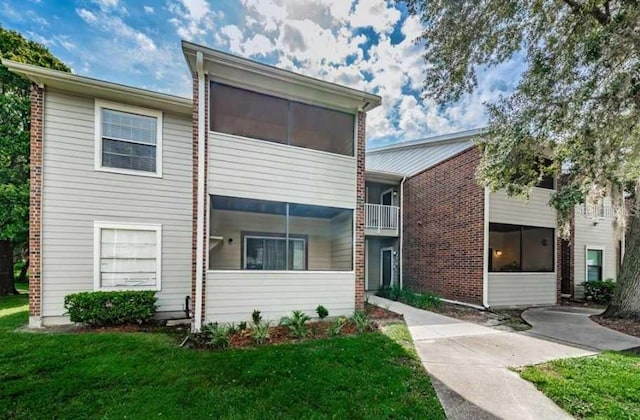 1400 Gandy Blvd N Unit 1705, Saint Petersburg, FL 33702 - view of front facade featuring a front lawn and brick siding