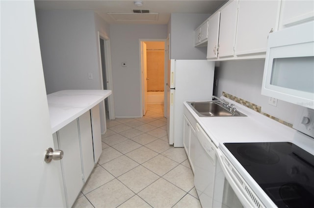1400 Gandy Blvd N Unit 1705, Saint Petersburg, FL 33702 - kitchen featuring white appliances, a sink, light countertops, light tile patterned floors, and white cabinets
