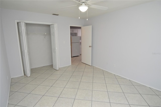 1400 Gandy Blvd N Unit 1705, Saint Petersburg, FL 33702 - unfurnished bedroom with freestanding refrigerator, a closet, ceiling fan, light tile patterned flooring, and baseboards