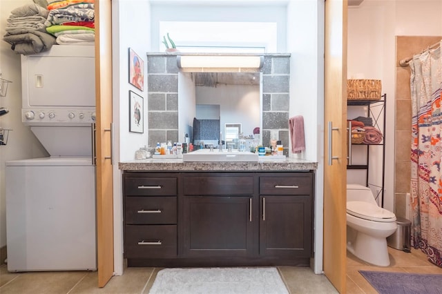 101 N 12th St Unit 400, Tampa, FL 33602 - full bath with stacked washer / drying machine, vanity, toilet, tile patterned floors, and a shower with shower curtain