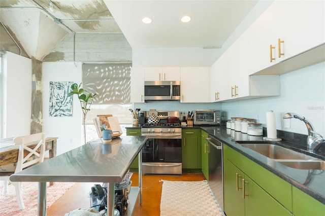 101 N 12th St Unit 400, Tampa, FL 33602 - kitchen with appliances with stainless steel finishes, a sink, decorative backsplash, white cabinets, and green cabinets