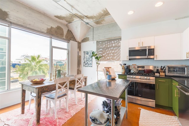101 N 12th St Unit 400, Tampa, FL 33602 - kitchen with stainless steel appliances, tasteful backsplash, white cabinets, dark countertops, and recessed lighting