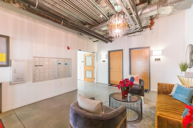 101 N 12th St Unit 400, Tampa, FL 33602 - living area featuring mail area, finished concrete flooring, a towering ceiling, and baseboards