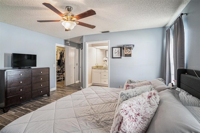 6118 Becklin Pl, Riverview, FL 33578 - bedroom with wood finished floors, a textured ceiling, a spacious closet, a closet, and ceiling fan