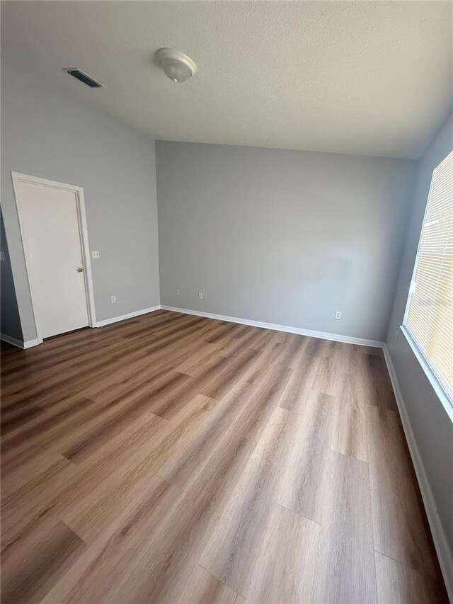 6025 Osprey Lake Cir, Riverview, FL 33578 - empty room with wood finished floors and baseboards