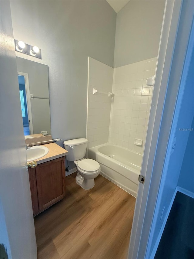 6025 Osprey Lake Cir, Riverview, FL 33578 - full bath featuring wood finished floors, toilet, vanity, and shower / tub combination