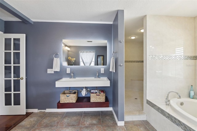 11029 Lynn Lake Cir, Tampa, FL 33625 - bathroom with a walk in shower, a bath, a sink, baseboards, and tile patterned floors