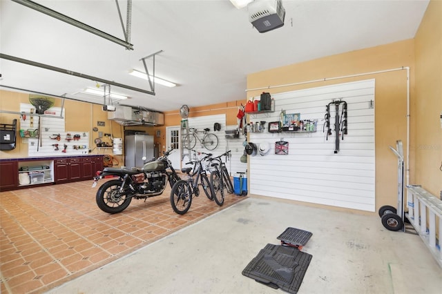 11029 Lynn Lake Cir, Tampa, FL 33625 - garage with a garage door opener, freestanding refrigerator, and a workshop area