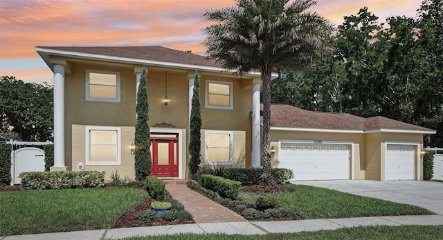 11029 Lynn Lake Cir, Tampa, FL 33625 - view of front of home with stucco siding, an attached garage, concrete driveway, and a lawn