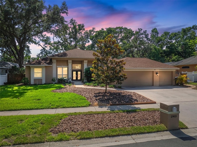 2903 Manor Ridge Pl, Valrico, FL 33596 - view of front of house featuring french doors, an attached garage, stucco siding, and concrete driveway