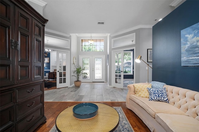 2903 Manor Ridge Pl, Valrico, FL 33596 - living area featuring wood finished floors, french doors, ornamental molding, and a chandelier