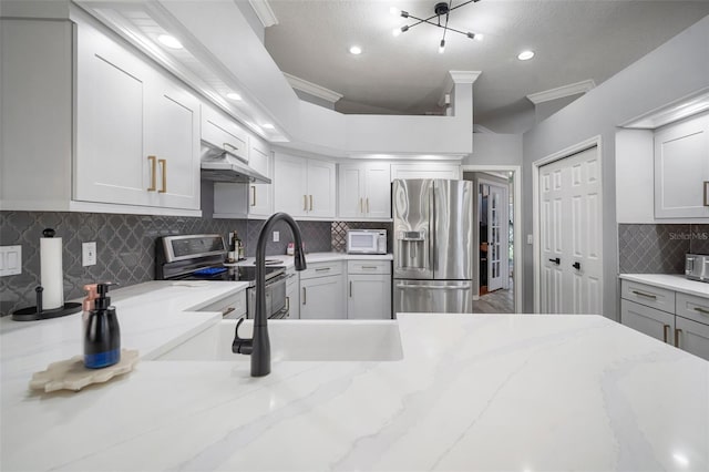 2903 Manor Ridge Pl, Valrico, FL 33596 - kitchen featuring stainless steel appliances, backsplash, under cabinet range hood, recessed lighting, and light stone counters