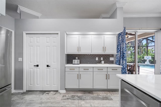 2903 Manor Ridge Pl, Valrico, FL 33596 - kitchen with stainless steel appliances, light countertops, ornamental molding, backsplash, and baseboards