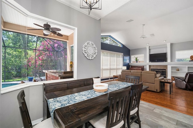2903 Manor Ridge Pl, Valrico, FL 33596 - dining space featuring ceiling fan, lofted ceiling, wood finished floors, and a tile fireplace