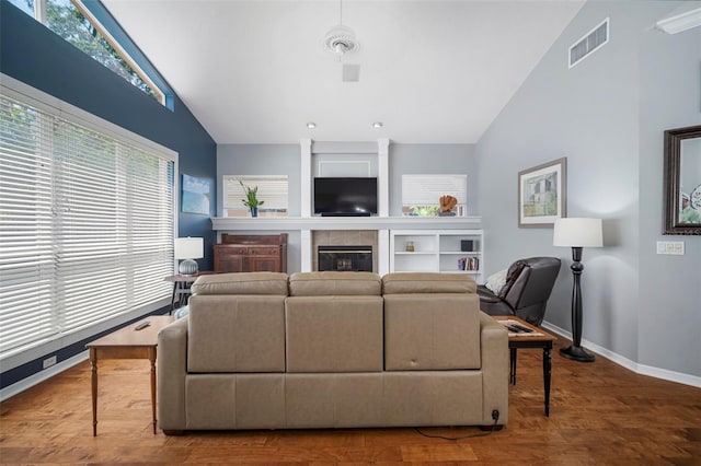 2903 Manor Ridge Pl, Valrico, FL 33596 - living area featuring vaulted ceiling, plenty of natural light, baseboards, wood finished floors, and a tile fireplace