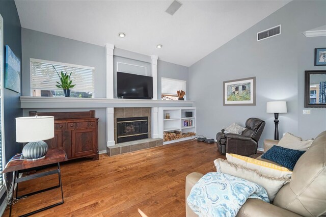 2903 Manor Ridge Pl, Valrico, FL 33596 - living room with light wood-style floors, a tile fireplace, high vaulted ceiling, and recessed lighting