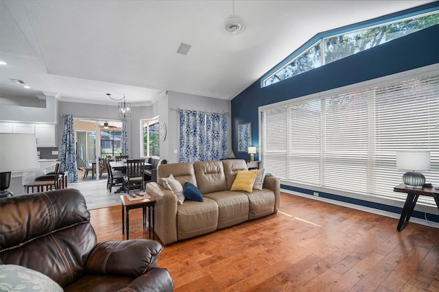 2903 Manor Ridge Pl, Valrico, FL 33596 - living area with wood finished floors, healthy amount of natural light, lofted ceiling, and a chandelier