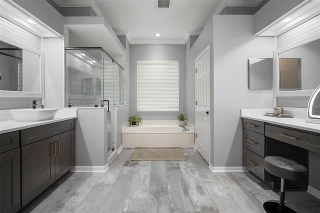 2903 Manor Ridge Pl, Valrico, FL 33596 - bathroom with a garden tub, a shower stall, wood finished floors, two vanities, and baseboards