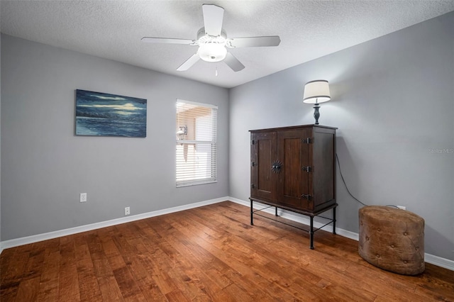 2903 Manor Ridge Pl, Valrico, FL 33596 - bedroom featuring wood finished floors, baseboards, a textured ceiling, and a ceiling fan
