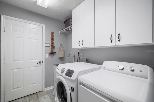2903 Manor Ridge Pl, Valrico, FL 33596 - washroom with cabinet space, washing machine and clothes dryer, a textured ceiling, and baseboards